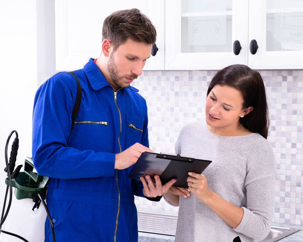 Brennan Termite and Pest Control technician explaining findings to Long Island homeowner